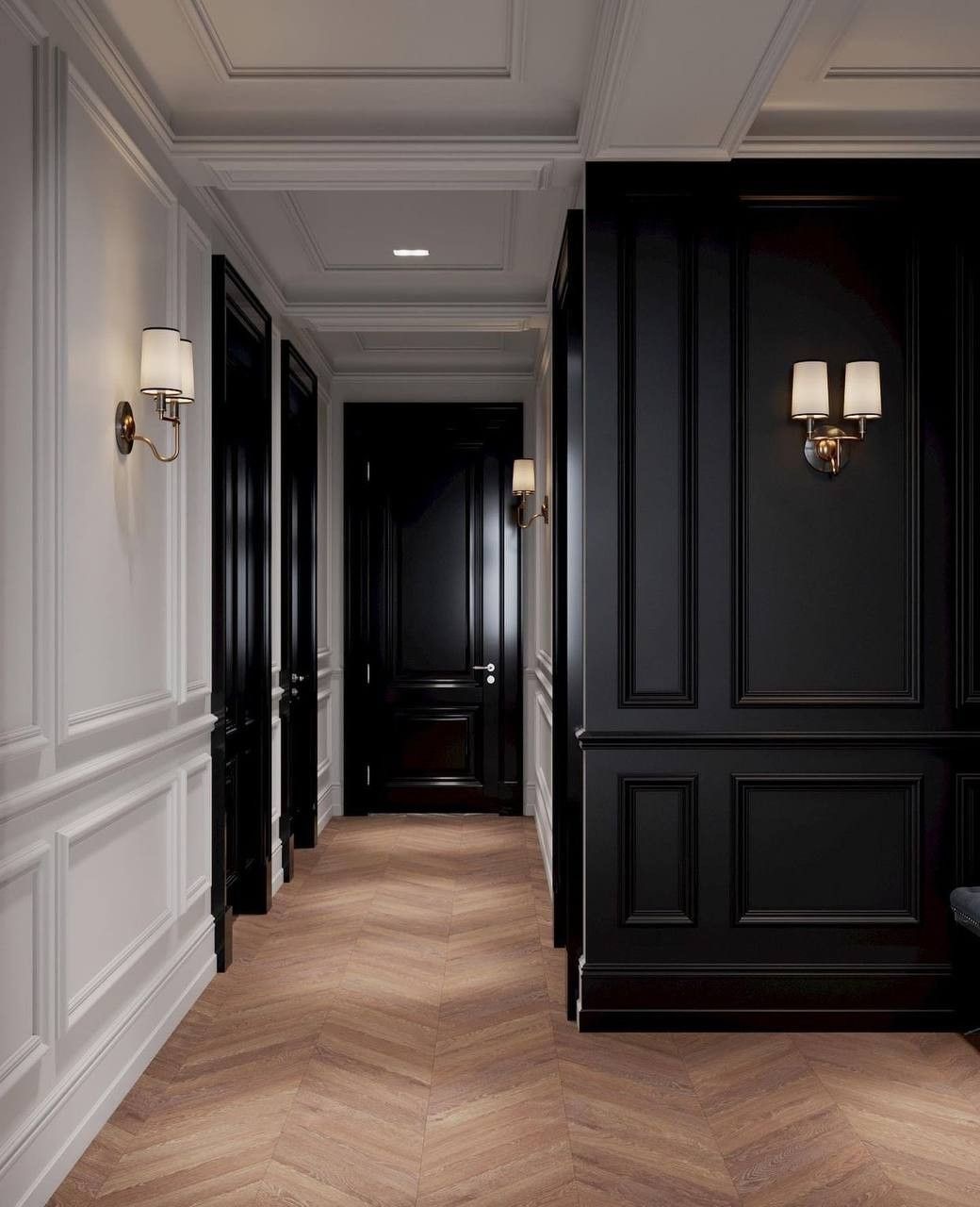 Panelled hallway with black lacquered doors, brass wall lights and herringbone floor