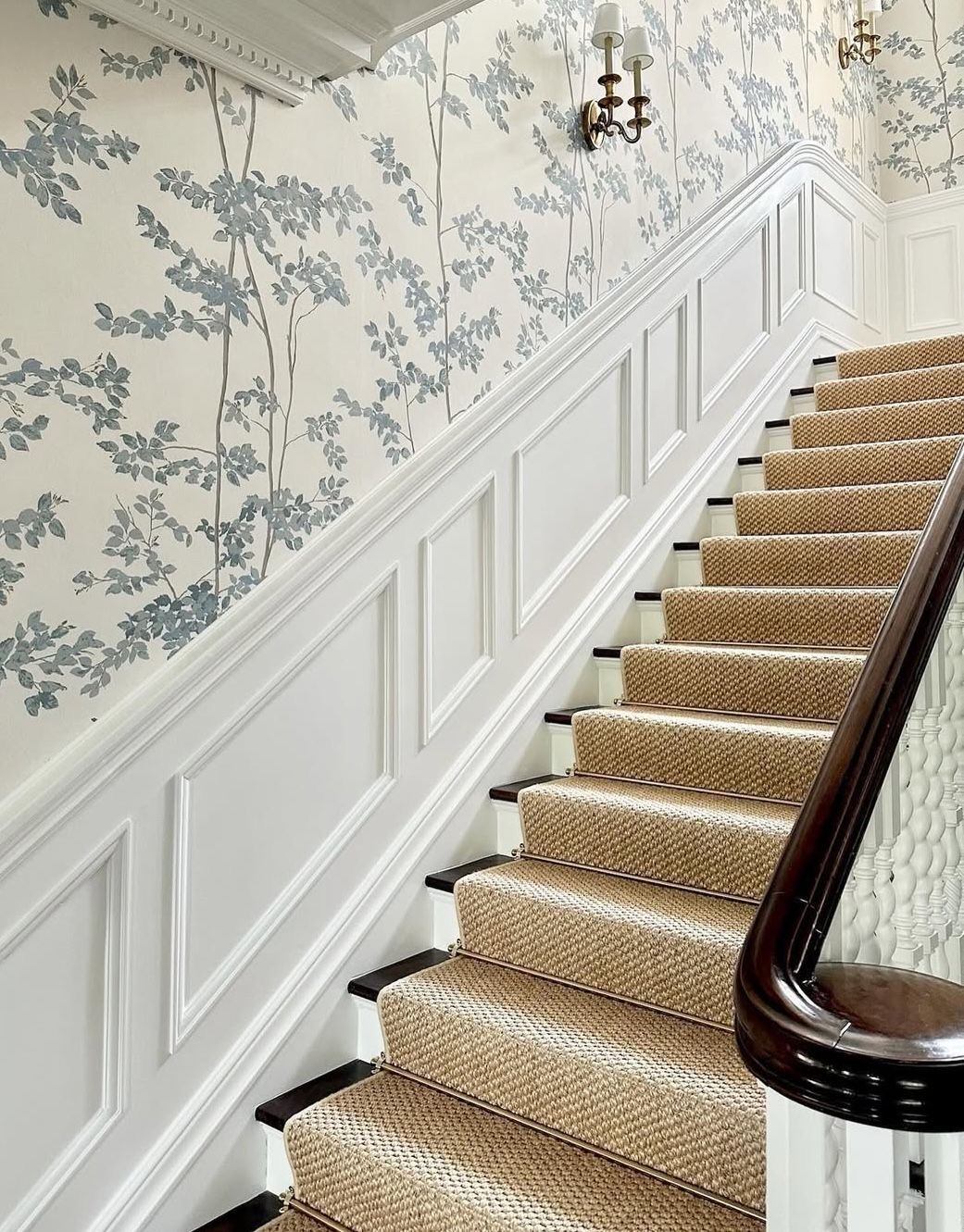 Panelled staircase hall with original joinery, brass fittings and herringbone treads